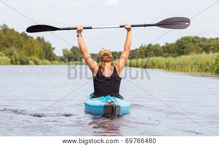 Woman On A Small River In Rural Landscape