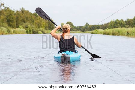 Woman On A Small River In Rural Landscape