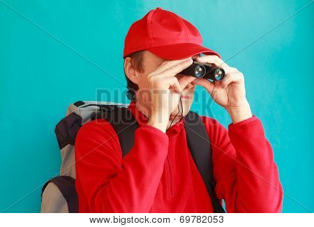 A Trekker During An Excursion Looking Through His Binoculars