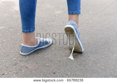 Foot stuck into chewing gum on street