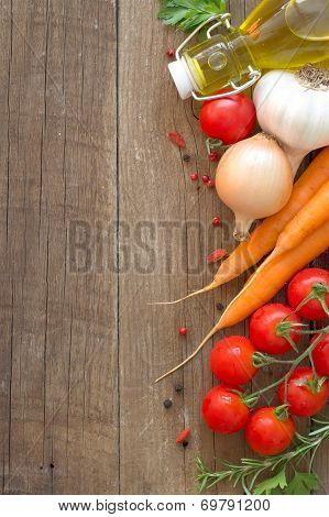 Organic Vegetables And Olive Oil On A Wooden Table