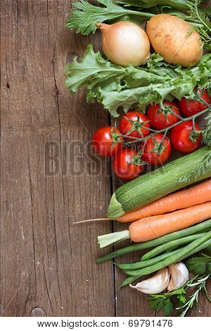 Organic Vegetables And Greens On A Wooden Table