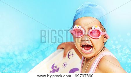 Happy little girl with cute swim goggles,in the summer