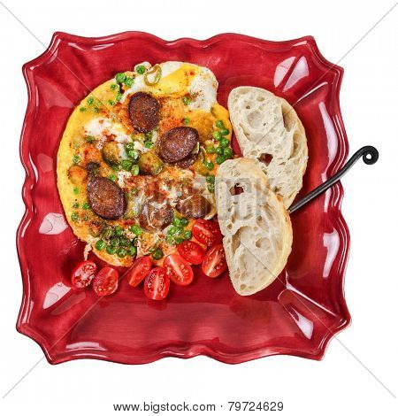 Omelette with sausage and sweet green peas on plate