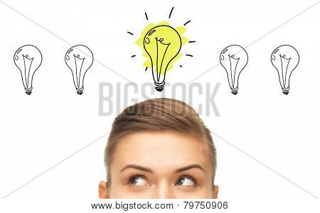 idea, business, education and people concept - close up of beautiful female eyes looking up to lighting bulb doodles