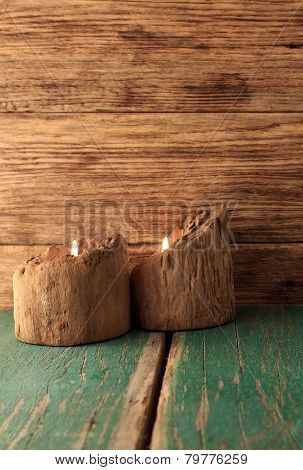 Two Candles Placed In Very Old Wooden Bars