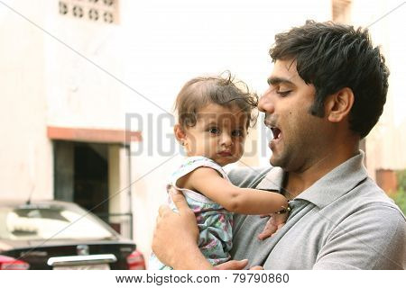 Indian Man playing with his daughter
