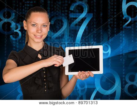 Smiling young woman holging tablet and card