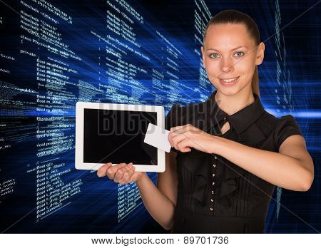 Smiling young woman holging tablet and card