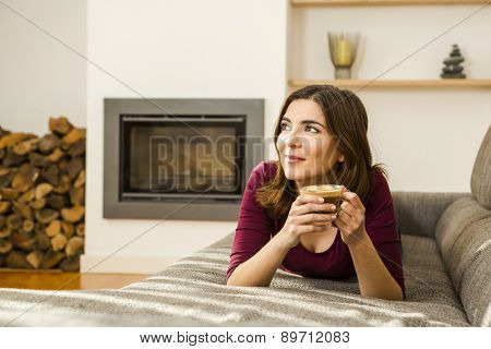 Beautiful woman at home drinking a capuchino