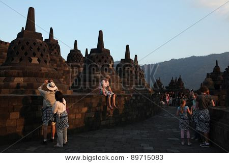 MAGELANG, INDONESIA - AUGUST 1, 2011: Tourists visit the Borobudur Temple in Magelang, Central Java, Indonesia.