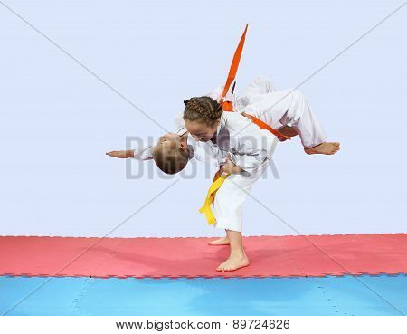 Children athletes are training on the mat
