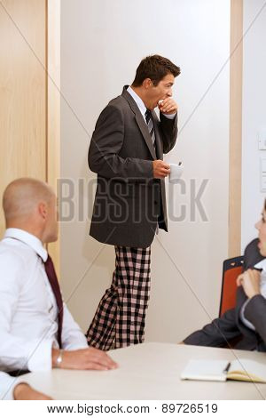 Young businessmen walkin across the corridor with pijamas pants