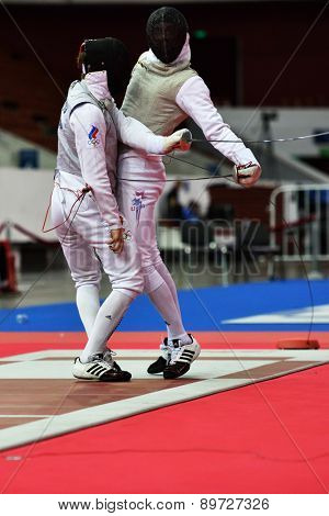 ST. PETERSBURG, RUSSIA - MAY 2, 2015: Roman Kuts of Russia (left) vs Race Imboden of USA in 1/64 final of International fencing tournament St. Petersburg Foil. The tournament is the stage of World Cup
