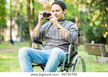 Portrait of a smiling man using a mirrorless camera