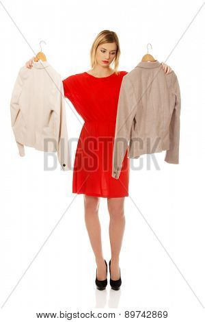 Beautiful woman thinking what to wear.