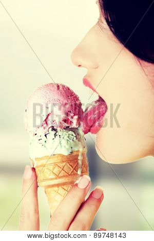 Young woman eating tasty ice cream