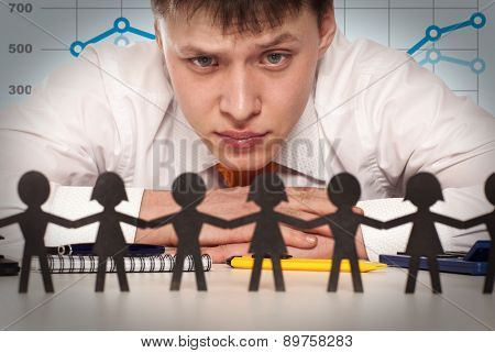 The boss looks at a group of people. Bureaucrat