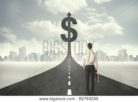 Business man on road heading toward a dollar sign concept