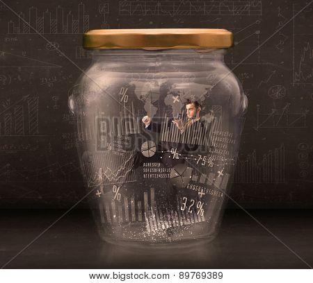 Businessman traped in jar with graph chart symbols concept on background