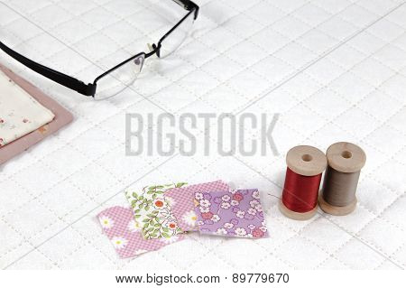 Accessory Needlework Put On White Patchwork Quilt Background