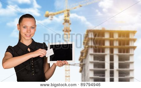 Young woman holging tablet and card