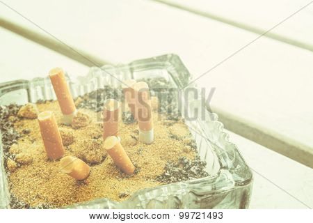 Cigarette butts in Ashtray vintage tone style