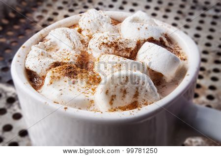 Mug of hot chocolate with marshmallows on table