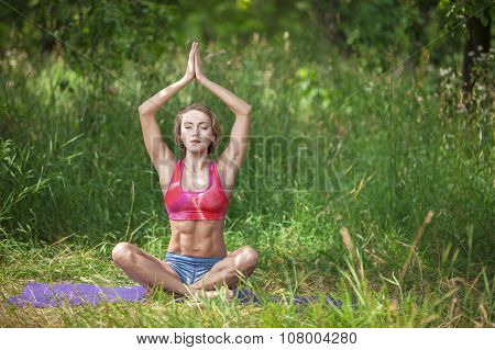 Young woman in lotus position.