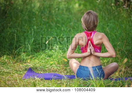 Young Caucasian woman meditating in lotus position.