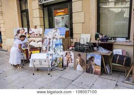 Local Woman Offers Paintings To Tourists