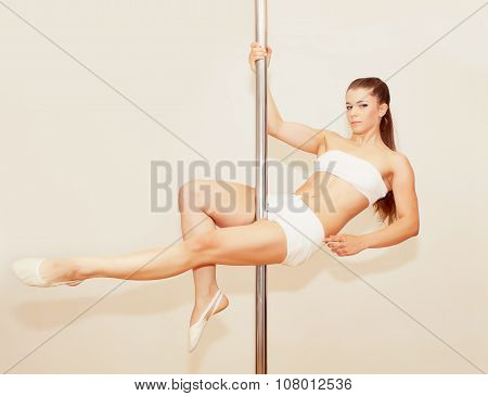 Poledance girl posing in studio