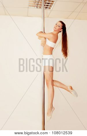 Poledance girl posing in studio