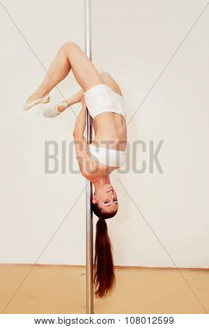 Poledance girl posing in studio