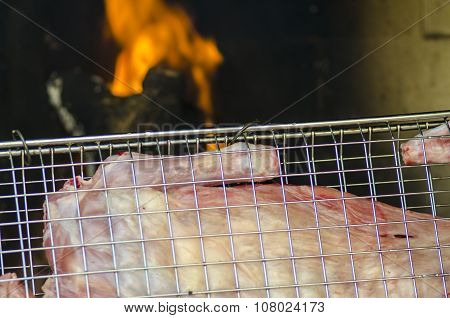 Grill With Meat For Barbecue Fire In Background