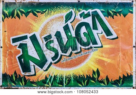 CHAINGRAITHAILAND - OCTOBER 13 : Old rust condition vintage wall of Mirinda logo in thailand language on October 13 2015 in Chaingrai Thailand.