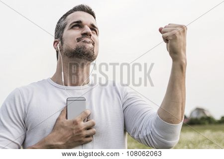 Happy young man in a field