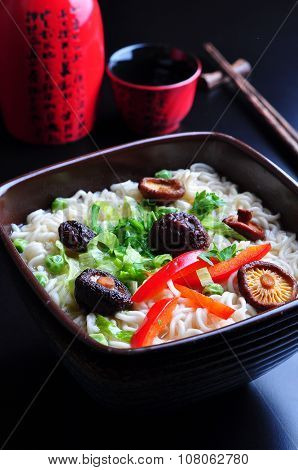 ramen noodles with shiitake mushrooms, green peas, sweet pepper and coriander