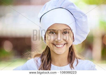Smiling girl in a chef's hat