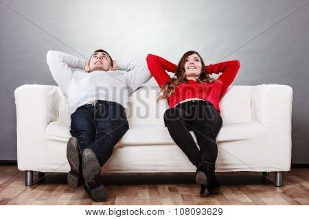 Happy Couple Relaxing Resting On Couch At Home.