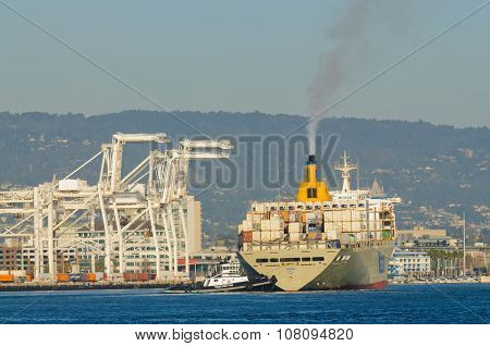 Alameda, CA - March 9, 2015: Oakland Container Shipyard, San Francisco Bay the tug tractor Z-Three maneuvering Matson container ship 