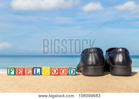 Word Feelgood In Colorful Alphabet Blocks And Black Shoe On Tropical Beach