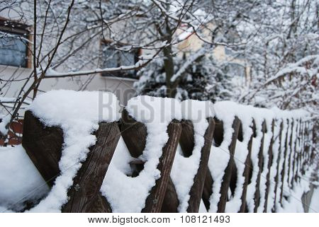 Detail Of A Wooden Fence Snow-covered