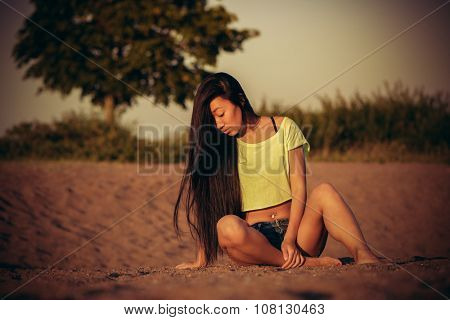 Woman sitting on the sand