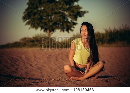 Woman sitting on the sand
