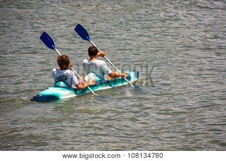 Florianopolis, Brazil - Jan 17, 2010. Guys paddling with a rented kayak on the sea in Florianopolis, Santa Catarina, Brazil.