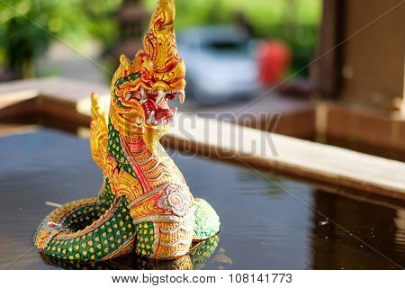 Naga statue rising on the pool