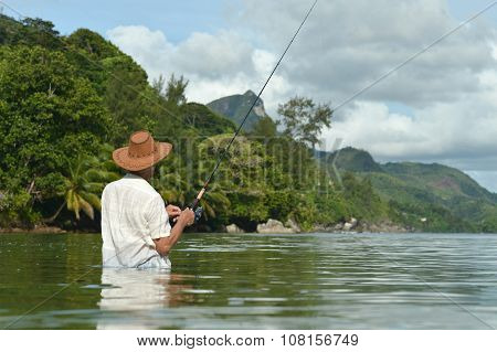elderly man fishing in the sea