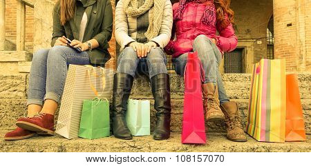 Three Girls Sitting And Chatting After Shopping In City  - Shopping And Tourism Concept - Warm Filte