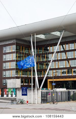 STRASBOURG FRANCE - 14 Nov 2015: European Union Flag flies at half-mast in front of the Counci lof Europe building Agora - following an terrorist attack in Paris